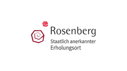 Rosenberg Logo mit stilisiertem rotem Rosen-Symbol und Text "Rosenberg Staatlich anerkannter Erholungsort".